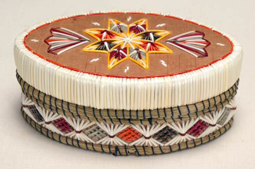 Oval lidded birch bark box with multi-colored quill work in a star and fan design